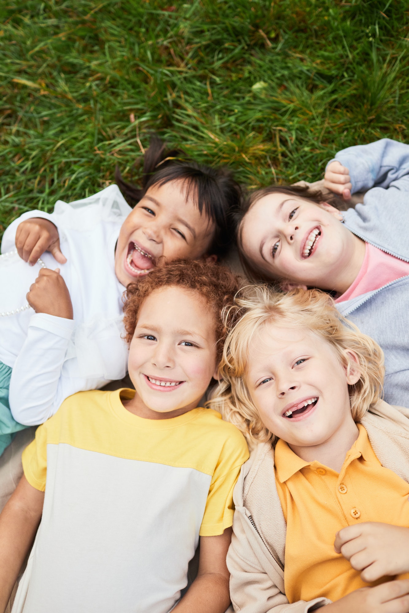 Smiling Children Lying on Grass